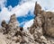 Young woman summerÂ hiker with backpack climbing with help of metal cables, iron rungs, pegs, and steps on huge limestone rock